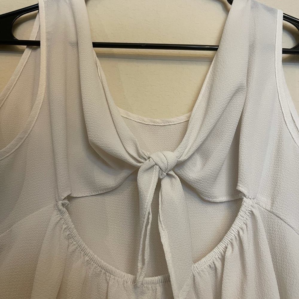 White Tank Top. Tie in the back. See through. Comfortable. Worn a couple times.